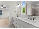 Bathroom featuring double sinks, framed mirrors, and gray tile shower at 106 Walters St, Huntersville, NC 28078