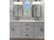 Bathroom featuring double sinks, framed mirrors, and black hardware at 106 Walters St, Huntersville, NC 28078