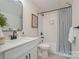 Stylishly designed bathroom with modern fixtures and a shower-tub combination with a striped shower curtain at 106 Walters St, Huntersville, NC 28078