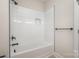 Modern bathroom featuring sleek white subway tile and a bathtub with a black showerhead at 106 Walters St, Huntersville, NC 28078