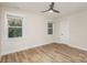 Unfurnished bedroom with neutral paint, new ceiling fan, and modern luxury vinyl flooring at 106 Walters St, Huntersville, NC 28078