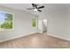 A bright bedroom with wood-look floors leads to an ensuite bathroom at 106 Walters St, Huntersville, NC 28078