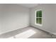 Bright bedroom featuring neutral paint and carpet, with a window looking out onto a lush landscape at 106 Walters St, Huntersville, NC 28078