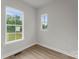 Bright bedroom featuring natural light and neutral paint, with wood-look flooring at 106 Walters St, Huntersville, NC 28078