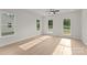 Bright, airy bedroom with large windows and modern ceiling fan, illuminated by natural light at 106 Walters St, Huntersville, NC 28078