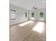 Bright bedroom featuring wood-look flooring, three windows, and a modern ceiling fan at 106 Walters St, Huntersville, NC 28078