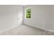 Bedroom featuring neutral paint, carpet, a window and door with white trim at 106 Walters St, Huntersville, NC 28078