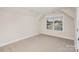 Bedroom with neutral carpet, window bringing in light, and angled ceilings at 106 Walters St, Huntersville, NC 28078