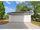 Detached two-car garage with a clean, white exterior and well-lit driveway at 106 Walters St, Huntersville, NC 28078