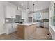 Well-designed kitchen featuring stainless appliances, a center island, and ample white cabinetry at 106 Walters St, Huntersville, NC 28078