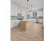 Bright kitchen boasts stainless steel appliances, white cabinets, a center island, and ample counter space at 106 Walters St, Huntersville, NC 28078