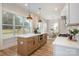 Open kitchen concept featuring a large island, stainless appliances, and view to dining area at 106 Walters St, Huntersville, NC 28078