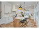 Modern kitchen with white cabinets, large island with seating, and stainless steel appliances at 106 Walters St, Huntersville, NC 28078