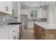 Modern kitchen featuring white cabinets, stainless steel appliances, and a large island at 106 Walters St, Huntersville, NC 28078