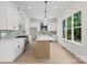 Modern kitchen with a center island, sleek countertops, stainless steel appliances, and bright natural light at 106 Walters St, Huntersville, NC 28078