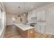 Open concept kitchen with large island, modern fixtures, and view into living area at 106 Walters St, Huntersville, NC 28078