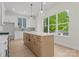 Bright kitchen featuring a large island, stainless steel appliances, and large windows at 106 Walters St, Huntersville, NC 28078