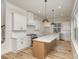Bright kitchen with white cabinets, quartz countertops, and large central island at 106 Walters St, Huntersville, NC 28078