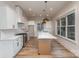 Spacious kitchen featuring white cabinetry, stainless appliances, and a functional island at 106 Walters St, Huntersville, NC 28078