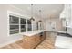 Bright kitchen with modern island and stainless steel appliances, open to dining area at 106 Walters St, Huntersville, NC 28078