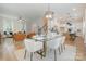 Open-concept living and dining area with hardwood floors, stylish furnishings, and ample space for entertaining guests at 106 Walters St, Huntersville, NC 28078