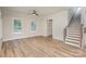 Bright living room with natural light, hardwood floors, and a staircase, creating an open and inviting atmosphere at 106 Walters St, Huntersville, NC 28078