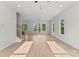 Bright and airy living room with hardwood floors, neutral walls, and large windows at 106 Walters St, Huntersville, NC 28078