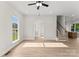 Open living room with hardwood floors, neutral paint, stairs, and ample natural light at 106 Walters St, Huntersville, NC 28078