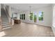 Open-concept living area featuring hardwood floors, modern lighting, and stairs at 106 Walters St, Huntersville, NC 28078