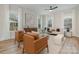 Stylishly furnished living room featuring hardwood floors, large windows, and comfortable seating, perfect for relaxation at 106 Walters St, Huntersville, NC 28078