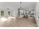 Bright open-concept living space with hardwood floors, an island, and modern finishes at 106 Walters St, Huntersville, NC 28078