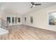 Spacious living area featuring hardwood floors, large windows, and modern ceiling fan, offering comfort and style at 106 Walters St, Huntersville, NC 28078