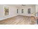 Bright living room with multiple windows, hardwood floors, and neutral decor, creating a cozy and inviting space at 106 Walters St, Huntersville, NC 28078