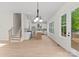 Open living room with hardwood floors, neutral paint, stairs, and ample natural light at 106 Walters St, Huntersville, NC 28078