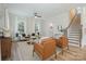 Cozy living room with hardwood floors, modern decor, and a staircase, providing a comfortable and stylish space at 106 Walters St, Huntersville, NC 28078