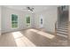 Sun-drenched living space with a staircase, windows, and direct front door access at 106 Walters St, Huntersville, NC 28078