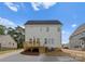 Back of house featuring a wooden deck, staircase, and a well-maintained yard with AC units at 106 Walters St, Huntersville, NC 28078