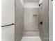 Tiled shower featuring gray marble-look tiles and a built-in bench at 106 Walters St, Huntersville, NC 28078