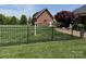 Fenced backyard features well-maintained lawn, landscaping, and an additional outbuilding on the property at 107 Cedar Lake Dr, Statesville, NC 28625