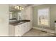 Bright bathroom featuring a granite countertop, white cabinetry, and a large mirror at 107 Cedar Lake Dr, Statesville, NC 28625