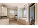 Spacious bathroom with a soaking tub, dual vanities, and tiled floors at 107 Cedar Lake Dr, Statesville, NC 28625
