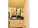 Well-lit bathroom with granite countertop vanity and framed mirror with views of other rooms at 107 Cedar Lake Dr, Statesville, NC 28625