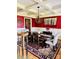 Elegant dining room boasts coffered ceilings, wainscoting, a wood table, and bright red walls at 107 Cedar Lake Dr, Statesville, NC 28625