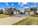 Long driveway leads to a brick home with a four-car garage, providing ample parking space at 107 Cedar Lake Dr, Statesville, NC 28625