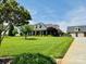 A spacious lawn surrounds a brick home with a detached garage and well-maintained landscaping at 107 Cedar Lake Dr, Statesville, NC 28625