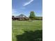 Beautiful brick home sits on a large lot, showcasing pristine landscaping and a well-manicured lawn at 107 Cedar Lake Dr, Statesville, NC 28625