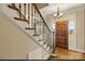 Traditional foyer featuring a staircase and beautiful hardwood front door at 107 Cedar Lake Dr, Statesville, NC 28625