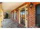 Inviting brick home featuring a covered front porch, elegant front door, and decorative outdoor lighting at 107 Cedar Lake Dr, Statesville, NC 28625