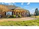 Charming brick home with a covered porch, featuring wood columns, brick accents, and mature landscaping at 107 Cedar Lake Dr, Statesville, NC 28625