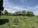 Expansive front yard with manicured lawn leads to a beautiful brick home with a covered front porch at 107 Cedar Lake Dr, Statesville, NC 28625